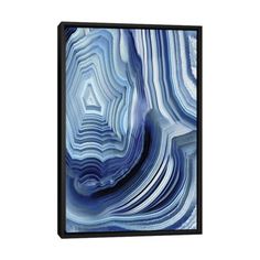 an abstract painting with blue and white stripes on the bottom, it is framed in metal