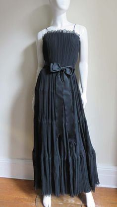 For Sale on 1stDibs - A black silk micro pleated gown from Jean Louis. The fitted bodice has a boned inner corset and spaghetti straps. The long full skirt is comprised of 4 Pleated Gown, Couture Vintage, 1950s Fashion, Vintage Clothes, Tiered Dress, Free Time, Fitted Bodice, Full Skirt, Black Silk