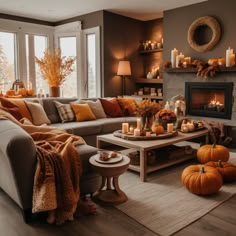 a living room filled with furniture and candles