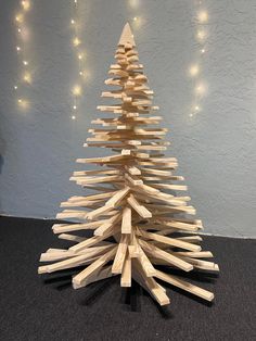 a wooden christmas tree made out of pieces of wood