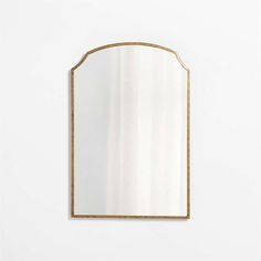 a gold framed mirror against a white wall