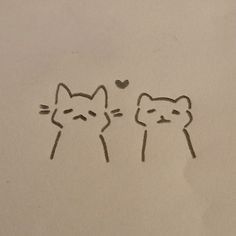 two cats are drawn on a piece of paper with the word love written in it