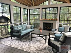 a living room filled with furniture and a fire place in the middle of a room