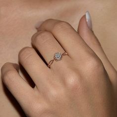 a woman's hand with a diamond ring on it