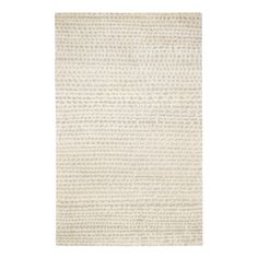 a white rug with small dots on the bottom, and a light brown area in the middle