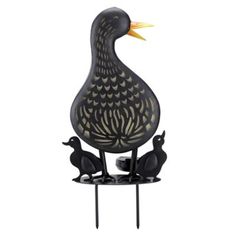 a metal duck and two ducks on a stand