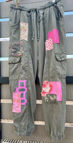 This listing is for a unique pair of upcycled Knox Rose L pants that have been patched and embellished with a variety of boho patches.  The patches have been made from thrifted or upcycled and vintage fabrics. Pockets are embellished with star studs.  These one of a kind drawstring pants are a work of art that are perfect for that boho look or festival wear.  Pair with boots, sandals, or your favorite Converse.    Measurements and fit 34" - 36" elastic adjustable waist 25.5 "inseam  11.5" front rise   50 " hips 25" thigh 11-13"  " ankle Stretch - no Rise is the most important measurement as it determines where the other measurements will hit on your body.  It is best to compare these measurements to your best fitting similar style pants for a perfect fit as returns are very costly.   Care: Upcycled Pants, Boho Hippie Fashion, Denim Patchwork Jeans, Boho Bottoms, Hippie Jeans, Army Green Pants, Altered Clothing, Upcycle Ideas, Hippie Fashion