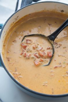 a pot filled with soup sitting on top of a stove