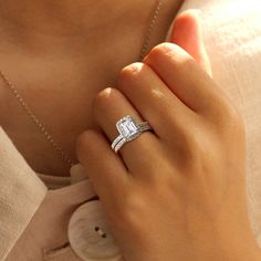 a woman's hand with a diamond ring on it