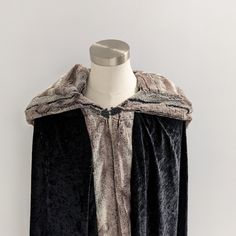 This beautiful hooded cloak is the perfect costume accessory for any medieval, Viking, huntress, or barbarian cosplay outfit. These cloaks are made with 2 layers of black velour fabric trimmed with soft pewter faux fox fur. The hood is extra large with black velour outside and lined with faux fox fur for dramatic effect. Sizing: Kids - 30" long (not including hood)Adult - 48" long (not including hood)Adult - 56" long (not including hood) Care: Machine wash on gentle cycle. Hang to dry. Viking Huntress, Barbarian Cosplay, Medieval Cloak, Black Cloak, Hand Muff, Superhero Capes, Hooded Cloak, Velour Fabric, Cosplay Outfits