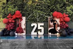 the number twenty five is displayed in front of some balloons and photos with red balls