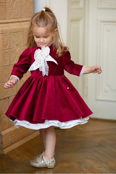 "A dress made from cotton velvet in a brilliant shade of Bordeaux with a Chantilly lace and pearl buttons jabot. The dress has pockets and a delicate underskirt. Depending on your preference, you can choose different lengths for the sleeves. Please measure the little one prior to ordering, to be sure the dress fits her. The measurements that you need to take are: Height Chest Circumference Waist Circumference Color:  Bordo, ivory. Composition: - cotton velvet, silk shantung; - cotton lining. Please check our SIZE CHART and cleaning instructions at \"Policies\" section!" Elegant Doll Collar Dress For Dress-up, Elegant Doll Collar Dress, Elegant Dress With Doll Collar, Elegant Vintage Dress With Doll Collar For Party, Elegant Christmas Velvet Dresses, Elegant Princess Dress With Ruffles For Costume, Elegant Winter Princess Dress With Ruffles, Elegant Holiday Costume Dress, Formal Ruffle Dress With Doll Collar