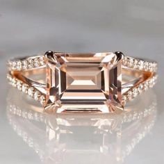 an engagement ring with a pink morganite and diamonds on the band, set in 18k rose gold