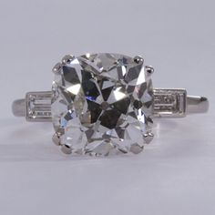 an oval cut diamond ring with baguetts on the sides