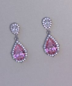 "Layla rose pink crystal earrings have the most beautiful sparkle due to the halo of tiny crystals surrounding both the earpost and the teardrop. We have used a clear crystal earpost which is also available as a clip on, to create a versatile and very pretty earring. Measurement: L-1\" (2.5cm) Set in non tarnish rhodium and are nickel, lead and cadmium free. 💙Clip on versions are available for this item. 💞 All our jewelry is presented in velvet pouches and high quality elegant, padded boxes re Glamorous Pink Teardrop Earrings, Pink Teardrop Jewelry With Halo Setting, Pink Teardrop Crystal Jewelry, Pink Earrings With Sparkling Cubic Zirconia Stones, Formal Pink Crystal Earrings, Pink Teardrop Earrings For Anniversary, Elegant Pink Teardrop Earrings, Elegant Pink Crystal Drop Earrings, Pink Crystal Earrings For Formal Occasions