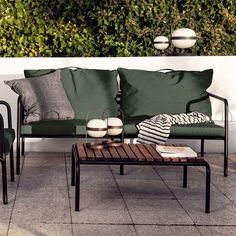 a green couch sitting on top of a wooden table