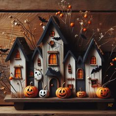 a group of halloween houses with pumpkins and jack - o'- lanterns