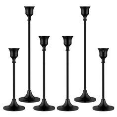 four black candlesticks are lined up in the same row on a white background