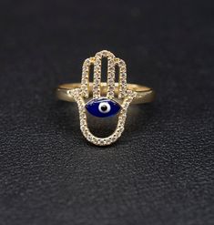 "14k Real Solid Yellow Gold Hamsa Hand Evil Eye  Ring, 14k Solid Gold Women Dainty Ring, Evil Eye Gold Ring for Women, Hamsa Hand Gold Ring, Minimalist Ring * Metal : Real 14K Yellow Gold, (Properly Stamped, 14K) * Condition : Brand New * Finish : Polished * Band thickness:2.4 mm  * Hamsa Hand Size: 18 mm length, 13mm width * Scale: : 6,5US, 7US, 7.5US, 8US, 8.5US * Stone: Cubic Zirconia These Rings are 100% Authentic 14K Solid Real Gold .  \"Not Plated or Filled\" This is a Beautiful Genuine Real 14K Solid Gold  Hamsa Hand With Evil Eye Ring BOSPHORUSGOLD" Evil Eye Gold Ring, Evil Eye Ring Gold, Evil Eye Hand, Evil Eye Art, Hand Evil Eye, Gold Ring For Women, Diamond Wallpaper, Gold Hamsa, Gold Jewelry Stores