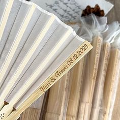 a close up of a fan on a wooden table with other items in the background