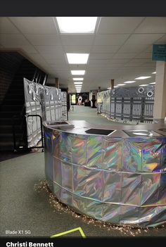 there is a large metal object in the middle of an empty hallway