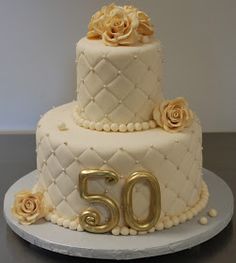 a 50th birthday cake with roses on top