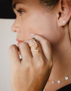 Intertwine yourself in luxury with our Snake Ring. The delicate snake design is expertly crafted with 14k gold plating and rhodium plating, exuding elegance and craftsmanship. Make a statement with this unique and timeless piece that alludes to the exotic and alluring world of the snake. Made in Colombia Yellow Gold Snake Ring For Wedding, Luxury Snake-shaped Wedding Ring, Adjustable Elegant Snake Ring As Gift, Elegant Adjustable Snake Ring As Gift, Adjustable Elegant Snake Ring For Gift, Elegant Snake-shaped Rings For Anniversary, Elegant Snake Ring For Anniversary, Elegant Snake Shaped Ring For Anniversary, Elegant Snake-shaped Anniversary Rings