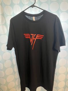 Van Halen Rock T-Shirt / Size is Large 100% cotton / Approx 27" from neck to bottom / 21" from pit to pit / 18" across the shoulders Vintage Van Halen logo from the days of classic rock Red Band Logo T-shirt, Rock Style Band Logo T-shirt With Crew Neck, Rock Style Crew Neck T-shirt With Screen Print, Rock Style Cotton T-shirt With Logo Print, Rock Style T-shirt With Logo For Concerts, Rock Style Tops With Band Logo, Rock Style Tops With Band Logo For Fans, Rock Band Logo Crew Neck Top, Rock Style Band Logo Crew Neck Top