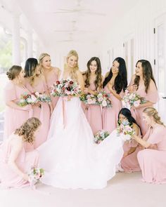 a group of women in pink dresses standing next to each other