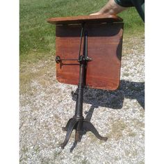 an old fashioned wooden music stand on the ground