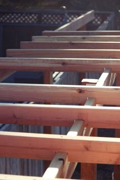 many wooden boards are stacked on top of each other in order to be used for construction