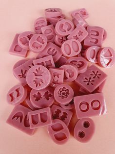 some pink plastic letters and numbers on a table