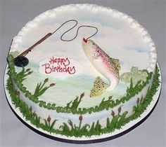 a birthday cake with a fish and fishing rod on the top is decorated in white frosting