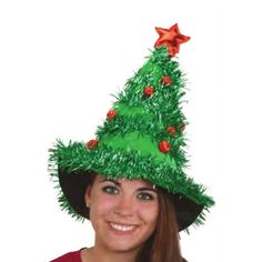 a woman wearing a green christmas tree hat