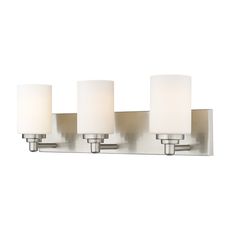 three light bathroom fixture in brushed steel finish with white linen shades on the glass panels