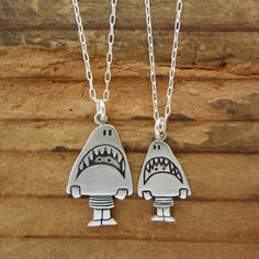 This cute set is a fun gift for your friends with kids. They are made from sterling silver, the mom measures 3/4" high and the daughter 1/2" high.  The daughter hangs from a 16" silver-plated cable chain and the mom hangs from an 18" silver-plated cable chain.If you have two kids:https://www.etsy.com/listing/87244713/two-kids-famiy-necklaceTo see the larger necklace click here:https://www.etsy.com/listing/517944382/sterling-shark-girl-necklace-cute-silverTo see the smaller necklace click here:ht Playful Silver Charm Necklaces, Fun Charm Necklaces For Gifts, Playful Silver Jewelry For Friendship, Personalized Sterling Silver Necklaces For Friendship, Cute Nickel-free Charm Necklace For Friendship, Cute Silver Sterling Silver Charm Necklaces, Personalized Novelty Jewelry For Mother's Day, Cute Silver Charm Necklaces, Fun Silver Jewelry For Friendship