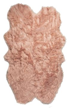 a pink sheepskin rug is shown on a white background with the fur in the shape of an animal's head