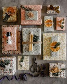 christmas presents are laid out on the floor with oranges and pine cones in them