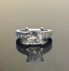 a princess cut diamond engagement ring with side stones