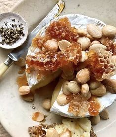 a white plate topped with fruit and nuts