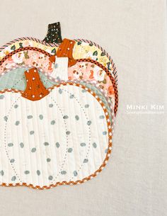 a quilted pumpkin sitting on top of a table