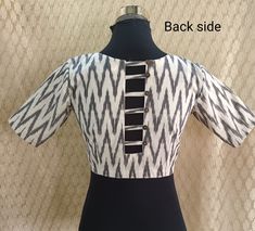 This is Indian traditional Ikat fabric handmade blouse. This is India's most popular fabric as it is very comfortable to body for all seasons. The pattern given to the blouse is quite trendy with closed back neck and beautiful loop button design is given at down. Front neck is in trendy V shape. Opening is given in front. Fabric : Pure cotton in Handloom Ikat You can pair this blouse with saree or a skirt or palazzo and pants as well.  Minor variations may appear in colour compared to  the image. We ship worldwide from India The Size available will  be 34-36-38  The blouse is fully covered with cotton lining inside. Care tip : Washable with hand and machine Please leave your contact no. with address as required by the courier company Please mail us for any query or suggestions. Thank You Front Button Blouse Design For Saree, Closed Neck Blouse Designs, Ethnic Crop Top, Ikat Blouse Designs, Ikat Blouse, Handmade Blouse, Indian Handloom, Blouse Designer, Sari Blouse Designs