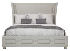 a bed with white linens and pillows on the headboard, in front of a white background