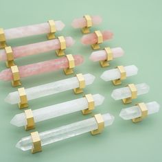 several pieces of pink and white crystal with gold bars