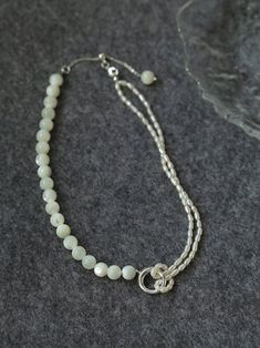 This stunning necklace features an elegant blend of 8mm natural white mother-of-pearl and delicate millet pearls, creating a chic half-and-half design that is both eye-catching and fashionable. With its sophisticated yet modern aesthetic, this piece brings an air of elegance and grace to any outfit. Whether paired with a dress, blazer, or knitwear, it adds a soft and refined touch, making it the perfect accessory for a variety of styles. Metal: Recycled Sterling Silver Plated On Brass Material: Elegant Single Strand Mother Of Pearl Necklace, Elegant Pearl Bracelet With Gemstone Beads, Elegant Pearl White Jewelry With Gemstone Beads, Double Strand Pearl Necklaces With Gemstone Beads, Elegant Mother Of Pearl Necklace With Gemstone Beads, Elegant Pearl Chain Beaded Necklaces, Elegant Pearl White Mother Of Pearl Beaded Necklaces, Elegant Cream Necklace With Pearl Charm, Elegant Cream Necklaces With Pearl Charm