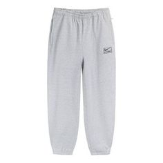 The Nike x Stussy Crossover SS22 Solid Color Logo Alphabet Embroidered Athleisure Casual Sports Pants Us Edition Unisex Gray is a must-have for any athleisure wardrobe. This unisex piece features an embroidered alphabet logo for a unique look, and the solid gray colorway is perfect for any occasion. The lightweight fabric is designed to keep you comfortable during any activity, and the adjustable drawstring waistband ensures a perfect fit. Inspired by the classic Nike x Stussy collaboration, this piece is perfect for any fan of the series. Get ready for any activity with the Nike x Stussy Crossover SS22 Solid Color Logo Alphabet Embroidered Athleisure Casual Sports Pants Us Edition Unisex Gray. (Casual/Unisex/Crossover/Embroidery/Solid Color/U.S. Edition/Gift to Boyfriend) Nike X Stussy Joggers, Nike Winter Sweatpants With Ribbed Waistband, Nike Winter Sweatpants, Nike Casual Winter Pants, Nike Casual Pants For Winter, Casual Sports Bottoms With Logo Detail, Nike Gray Sweatpants For Streetwear, Nike Cotton Sweatpants For Winter, Nike Winter Pants With Elastic Waistband