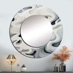 a mirror sitting on top of a table next to a vase