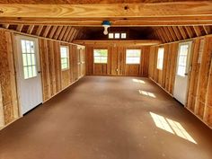 an empty room with wood paneling and windows in the ceiling is seen from the inside