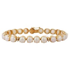 Pearl and Diamond bracelet in 18K Gold. It has a perfect round cut gemstone to make you stand out on any occasion or an event. A tennis bracelet is an essential piece of jewelry when it comes to your wedding day. The sleek and elegant style complements the attire beautifully, whether it's the bride wearing it herself, or as a gift to her bridesmaids to wear on the D’day. PRODUCT DETAILS :- > Material - 18K Solid Yellow Gold > Gemstone - Pearl > Stone Weight - 34.25 ct > Stone Shape - Round > Sto Luxury Round Pearl Bracelet, Luxury Gold Plated Jubilee Pearl Bracelet, Perfect Engagement Gifts, Modern Bracelets, Pearl Stone, Birthstone Bracelet, Birthstone Bracelets, June Birthstone, Pearl Set