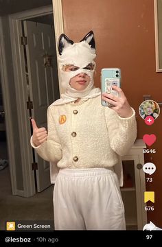 a person with a cat mask on taking a selfie